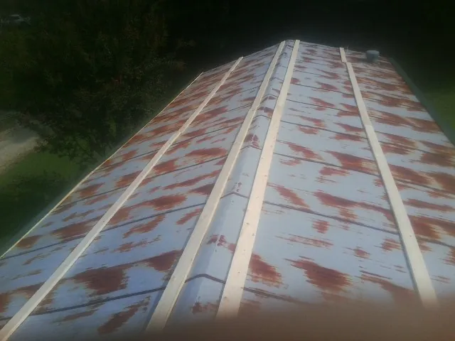 Rusted metal roof panels with new wood purlins before replacement — Storm Damage Roof Repair in Big Bend by Roofing Brothers