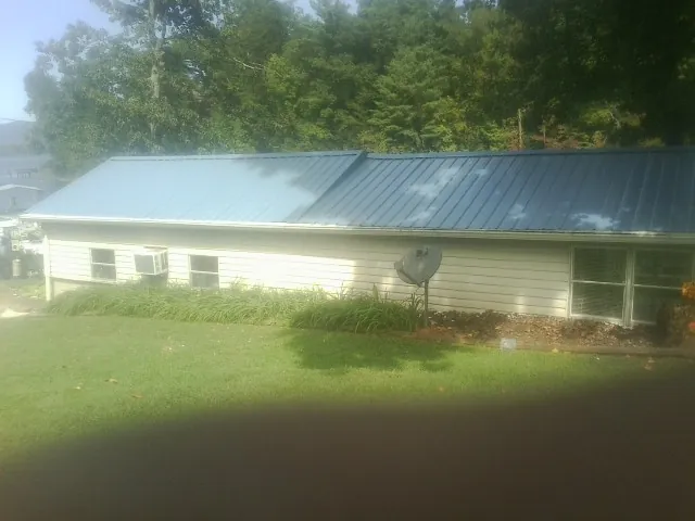 Blue metal roof running the length of a single story home in Big Bend